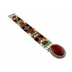 Chili Rose Mini Aragon Black Fortuna Bracelet Carnelian Stone lays in the middle of the Bracelet when on the wrist -19mm wide -Hand Beaded on a Loom -Red, Turquoise, Jet and Olive colored Beads -Sterling Silver -Interlocking Clasp Closure -Made in Santa Fe, New Mexico -Length: 7in. -*Length can be custom made, just let us know at checkout! Anything over 8in. is an additional charge* Multicolor Cabochon Bracelet, Artisan Cabochon Bracelet Jewelry, Artisan Multicolor Gemstone Bracelets, Unique Adjustable Bracelets With Cabochon, Red Gemstone Beaded Bracelet Bohemian Style, Red Bohemian Beaded Gemstone Bracelet, Unique Adjustable Cabochon Bracelets, Adjustable Cabochon Bangle Bracelets, Rectangular Multicolor Bracelet