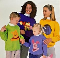 three women and two children wearing winnie the pooh sweaters