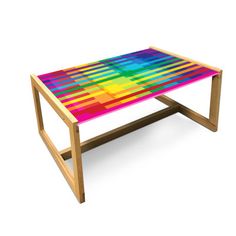 a multicolored coffee table sitting on top of a white surface with wooden legs