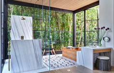 the bathroom is decorated in white marble and wood