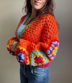 Bright Orange Handmade Crochet Cardigan - A Unique, One-of-a-Kind Design This handmade cardigan is truly one of a kind, crafted with care and designed to make a bold fashion statement. Featuring vibrant orange hues--2025's trendiest color--and charming flower granny squares on the sleeves, this cardigan is perfect for anyone who loves bright, cheerful designs. The body is crafted with a lightweight granny stitch, making it versatile enough for all seasons. Whether you layer it for cooler weather or wear it as a statement piece in spring or summer, this cardigan brings effortless style to any wardrobe. Completely freehand and inspired by creative ideas, this relaxed-fit cardigan is available in women's size S/M. Its no-sew sleeve attachment ensures durability and comfort, while the intricat