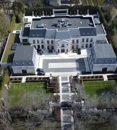 an aerial view of a large white house