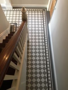 the stairs are lined with black and white tiles