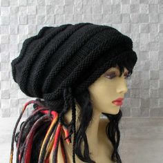 a mannequin head wearing a black knitted hat with dreads on it