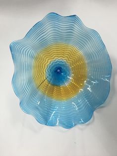 a blue and yellow flower shaped glass dish