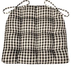 a black and white checkered pot holder with two ties on the back of it