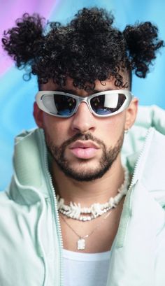 a man wearing sunglasses and a hoodie with an afro on his head is looking at the camera