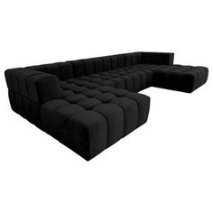 a large black couch sitting on top of a white floor