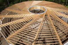 a wooden structure is being built in the woods