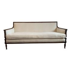 a white couch sitting on top of a wooden frame