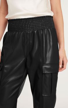 Experience the luxurious comfort and style of our Lite Vegan Leather Jenning Pants. Made from high-quality vegan leather in a classic black color, these pants feature a trendy jogger silhouette and an elastic waistband and pant cuffs for a perfect fit. Embrace a guilt-free and fashionable lifestyle with these must-have pants. Details Pull on silhouetteFabric: Faux LeatherElastic waistband and cuffsSide pocketsCropped Content and Care 100% PolyesterDry Clean Only Imported Measurements 26.5in/68.5 Trendy Joggers, Skirt Coverup, Pants Details, Short Denim Skirt, Evening Tops, Denim Outerwear, Cuffed Pants, Tank Top Camisole, Guilt Free