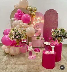 a birthday party with balloons, flowers and cake