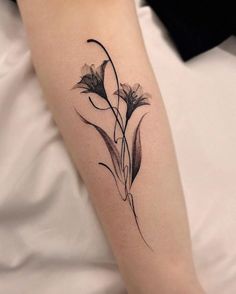 a black and white photo of a flower tattoo on the left upper half of the arm