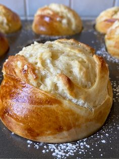 some bread rolls sitting on top of a baking pan