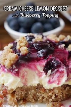 a close up of a dessert on a plate with blueberries and crumbs