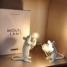 two white mouse lamps sitting on top of a table