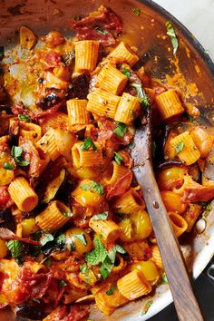 a skillet filled with pasta and vegetables