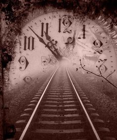 a black and white photo of a train track with a clock on the wall behind it