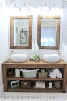 a bathroom with two sinks and mirrors on the wall next to a shelf filled with toiletries