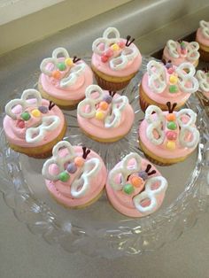 cupcakes with pink frosting and decorated numbers on them