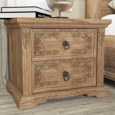 a wooden nightstand sitting on top of a bed