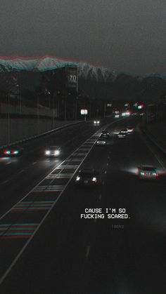 cars driving down a highway at night with red and green lights in the dark sky