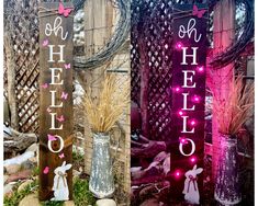 three wooden signs that say hello, hello and hello with pink lights on them in the grass