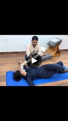 a man sitting on top of a blue mat next to a woman laying on the floor