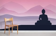 a buddha statue sitting on top of a wooden chair in front of a wall mural