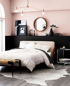 a bedroom with pink walls and white bedding