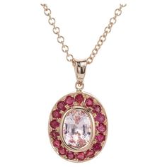 Oval soft light pink sapphire center stone, bezel set with a halo of 17 round bead set rubies. On Peter's now famous pink gold scale of 1 to 10 with 10 as the deepest pink this scores an 8. 18 inch 14k rose gold chain. 1 oval pink sapphire approx. total weight 1.71cts 17 round rubies approx. total weight .81cts 14k Rose Gold Stamped: 14k 2.5 grams 5/8 x ½ inch Overall length: 7/8 inch including the bale Rose Gold Pendant Necklace, Rose Gold Chain, Rose Gold Pendant, Gold Pendant Necklace, Pink Sapphire, Soft Lighting, Round Beads, Gold Pendant, Or Rose