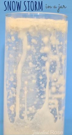 a glass filled with ice and water on top of a blue background that says, how to make snow storm in a jar