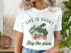 a woman wearing a t - shirt that says life is shopt buy the plant