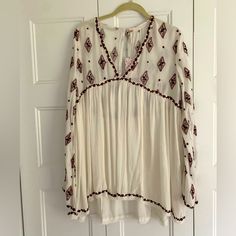 Nwt Free People Tunic. Beautiful Maroon Embroidered Ivory Top With Plunge Neckline And Open Back. Size Small, But Made Oversized. Flowy Embroidered White Tops, Flowy White Embroidered Top, White Embroidered Top For Fall, White V-neck Top With Embroidered Hem, White Embroidered V-neck Top, White V-neck Embroidered Top, Free People Tunic, Ivory Tops, Plunge Neckline