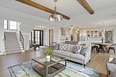 a living room filled with furniture and lots of windows