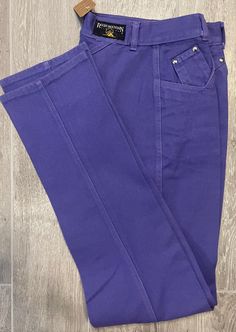 "Vintage Rocky Mountain Jeans Light Purple Black & Yellow Tag Best Fits: Size: 25\"  Inseam 33\"Vintage Size: 26/3 🌵Please Note🌵Vintage sizes can differ greatly from modern day sizing.  Please message with any questions prior to purchase. ✨All Sales Final ✨No Returns✨" Retro Stretch Cotton Jeans, Fitted Vintage Cotton Bottoms, Retro Stretch Jeans With Pockets, Vintage Stretch Cotton Bottoms, Vintage Cotton Jeans For Work, Retro Fitted Jeans, Vintage Stretch Pants, Fitted Retro Jeans, Retro Cotton Jeans For Work