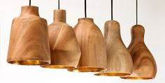 five wooden vases are hanging from strings