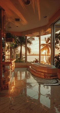 an indoor jacuzzi tub in the middle of a room with large windows and palm trees