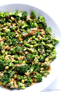 broccoli and chickpeas are mixed together in a white bowl on a table