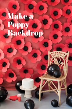 a chair sitting in front of a red and black wall with poppies on it