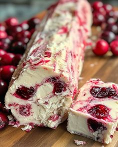 cranberry cheesecake on a cutting board with cherries