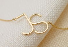 This is a solid gold necklace with two initials, well made and modern looking. Each initials necklace is made from scratch just for you - so you will be able to customize your design. Each letter is about 0.65 inch tall, with the total pendant measurements vary on design. Pendant could hang sideways, tilted or straight. Every part of the necklace is solid 14K gold, you can order your necklace in yellow, rose or white gold, price stays the same. You can add a diamond ($45/ea.) or a colored gemstone ($15/ea.) I use 2mm round natural gemstones and diamonds. To the design, send me a request if you would like to see your necklace with birthstones. To add more birthstones https://etsy.me/31k4A1z To add more diamonds https://etsy.me/318joQF Different chain lengths are available in the drop down m Gold Custom Necklace For Anniversary, Modern Gold Initial Necklace For Anniversary, Elegant Tan Monogram Initial Necklace, Gold Initial Necklace For Anniversary With Polished Finish, Elegant Initial Necklace With Polished Finish For Anniversary, Gold Initial Necklace With Polished Finish For Anniversary, Anniversary Yellow Gold Initial Necklace With Polished Finish, Formal 14k Gold Name Necklace With Initials, Formal 14k Gold Initials Name Necklace