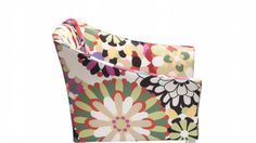 an upholstered chair with colorful flowers on the back and sides, sitting in front of a white background