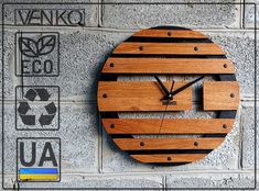 a clock made out of wood sitting on top of a wall