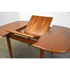 two wooden tables sitting on top of each other with one table open and the other closed