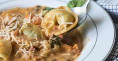 a white plate topped with pasta and dumplings