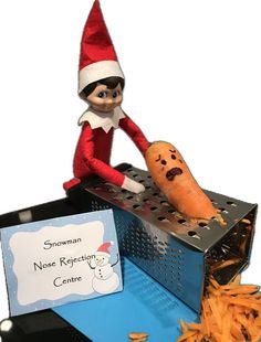 an elf is sitting on top of a metal grater with a carrot in front of it