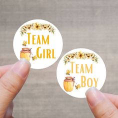 two round stickers with the words team girl and a jar of jam on them