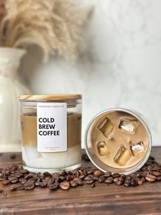 a cup of coffee next to a jar of cold brew coffee