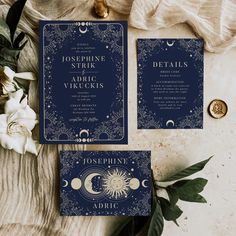 two blue wedding cards with the moon and stars on them, next to some flowers